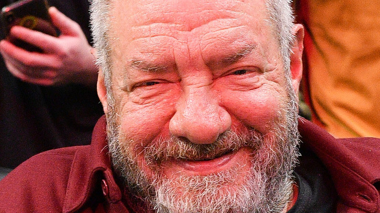 Dick Wolf smiling at a basketball game