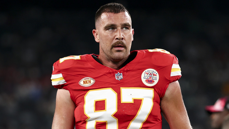 Travis Kelce walking on the football field