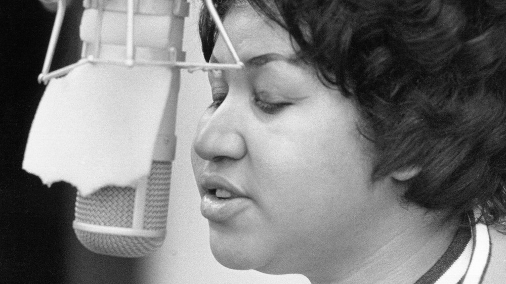 Aretha Franklin singing into microphone