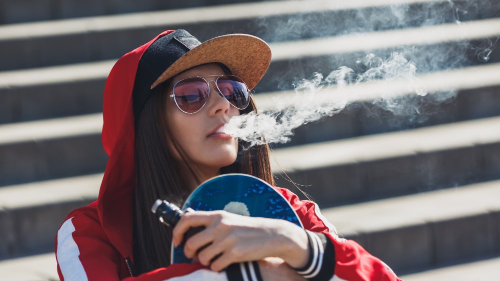 Girl vaping in a park