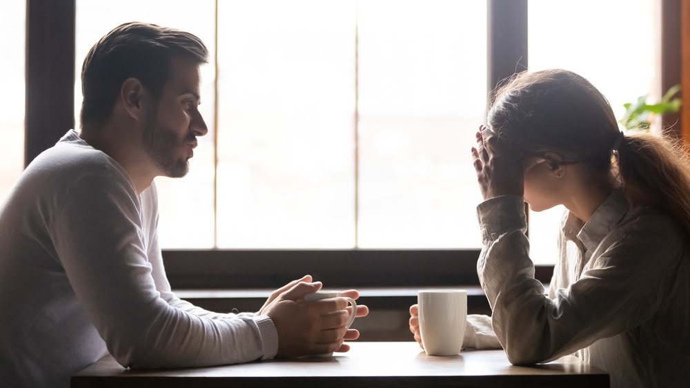 couple having difficult conversation over coffee