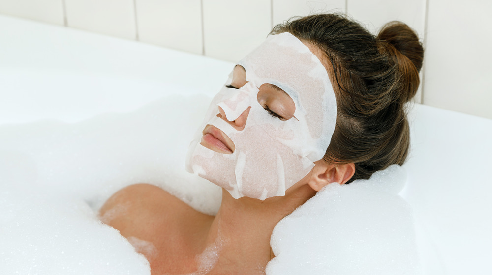 Woman using a sheet mask