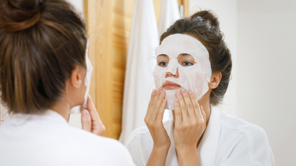 Woman using a sheet mask