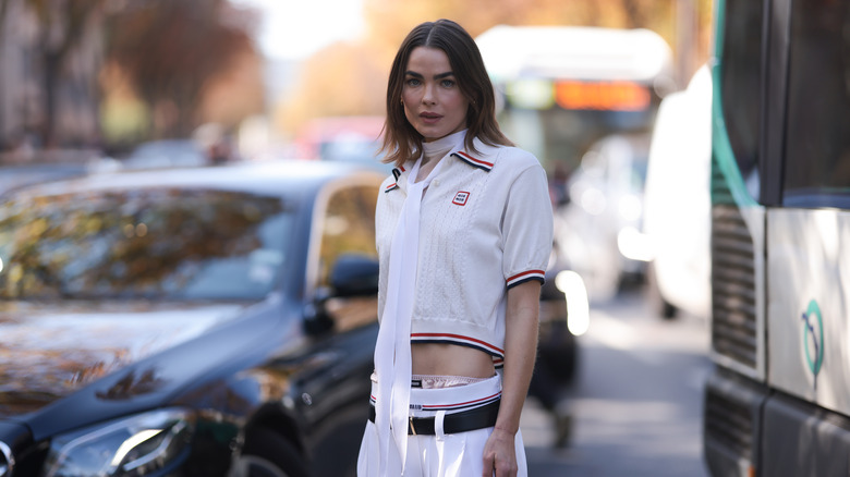 woman wearing polo crop top with mini skirt