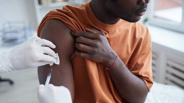 Young man getting COVID vaccine