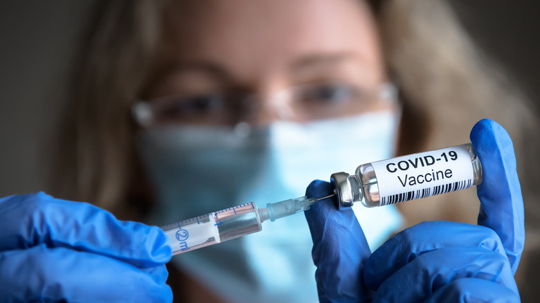 Woman holding Covid-19 vaccine