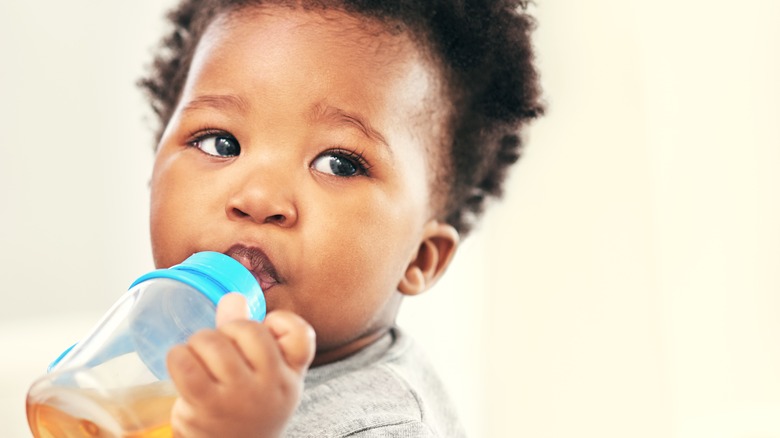 baby drinking from sippy bottle