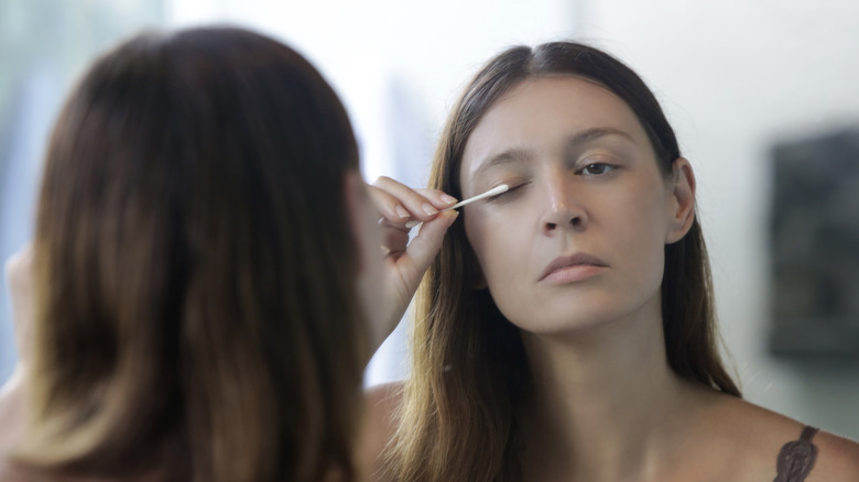 Woman applying Latisse to her lashes