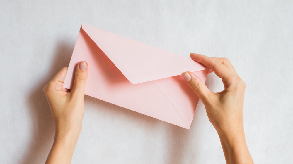 woman holding an envelope