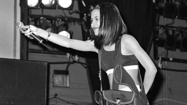 Aaliyah holding out her microphone