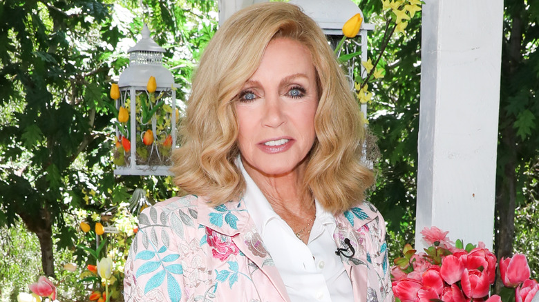 Donna Mills outside with flowers