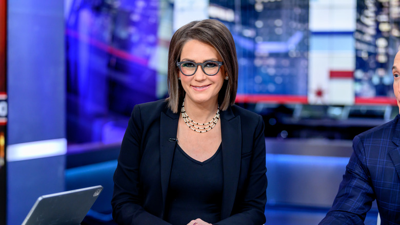 Jessica Tarlov sitting behind a desk in a TV studio