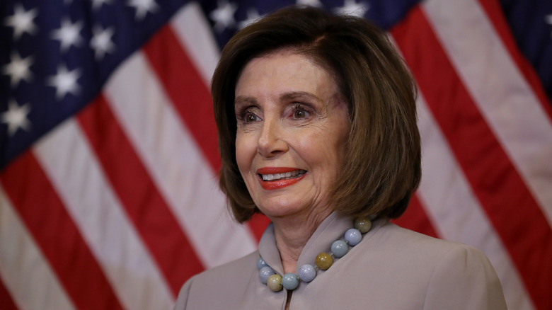 Nancy Pelosi in front of flag