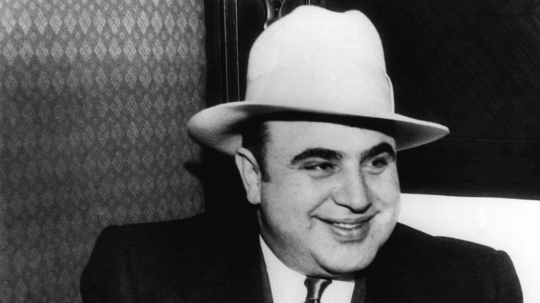 Al Capone smiling and wearing a hat
