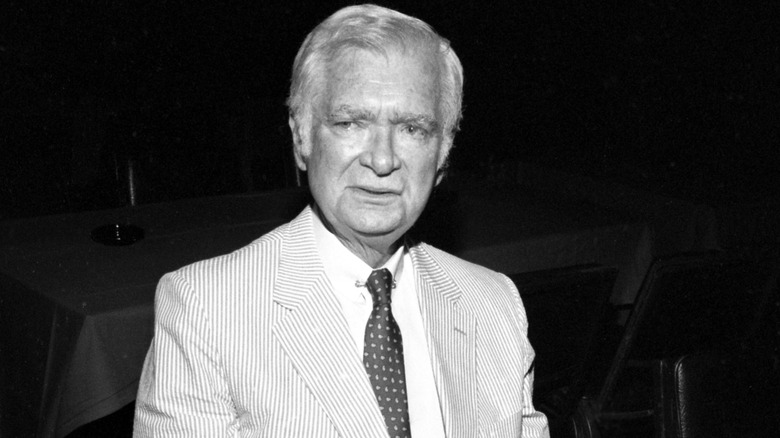 Buddy Ebsen wearing a suit and tie