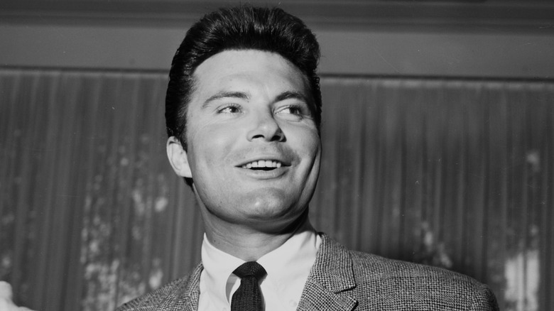 Max Baer Jr. wearing a suit and tie