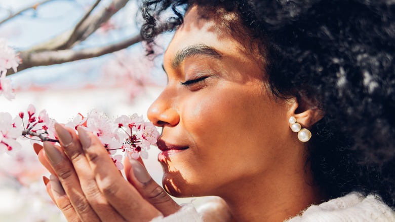 Woman smelling flowers