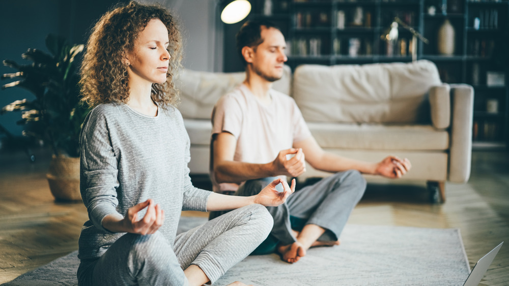 Meditative couple in living room