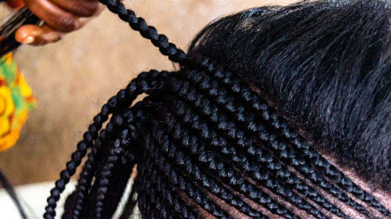 Woman getting cornrows