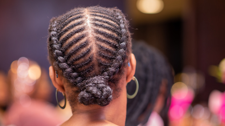 Woman with intricate cornrow braids