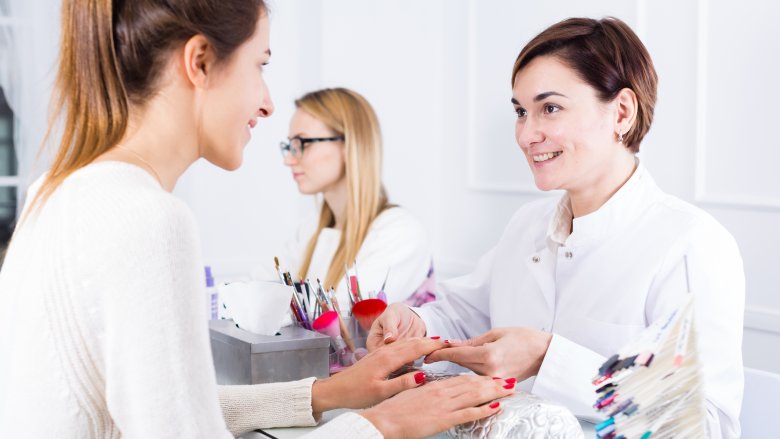 woman and nail technician