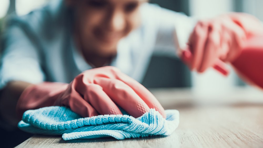 Woman cleaning a household surface