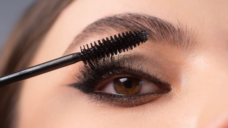 Woman applying mascara 