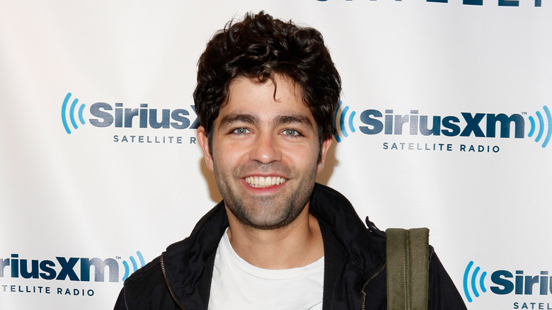 Adrian Grenier smiling at SiriusXM studios in 2011