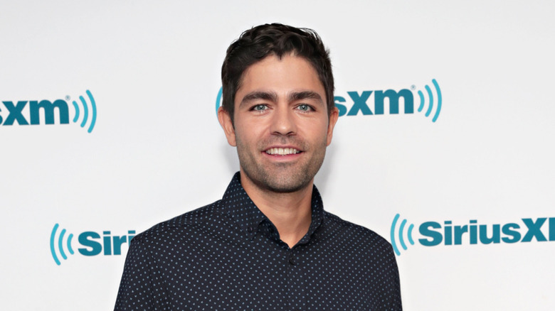 Adrian Grenier smiling at SiriusXM studios in 2017