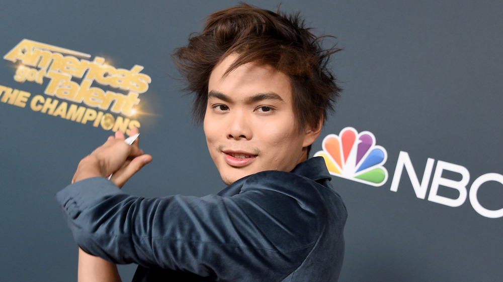 Shin Lim holds cards at AGT event