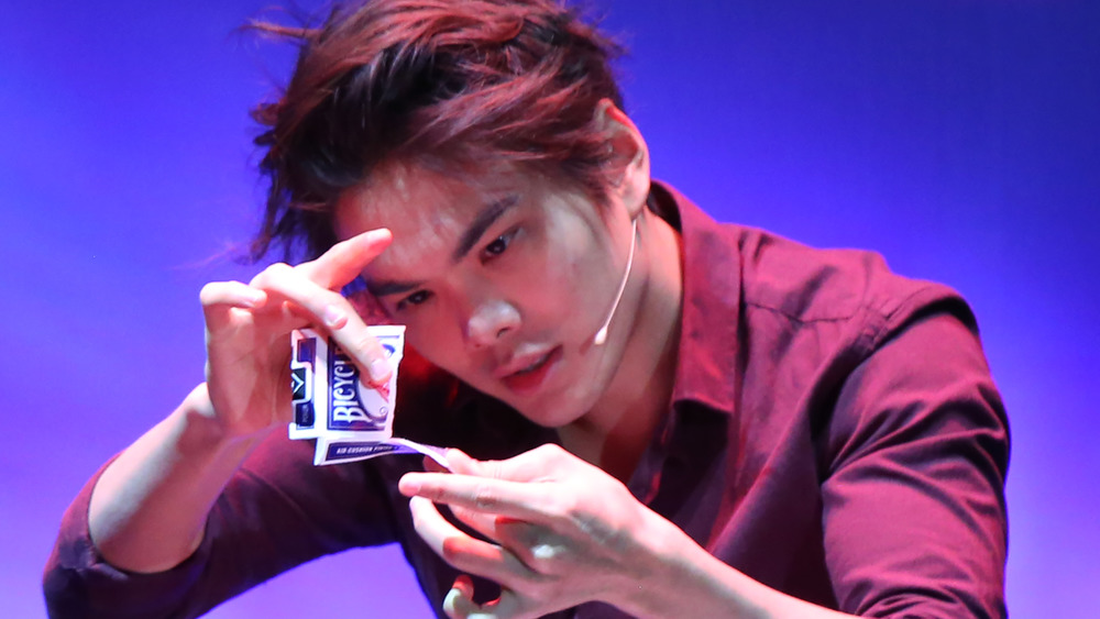 Shin Lim does a card trick on stage