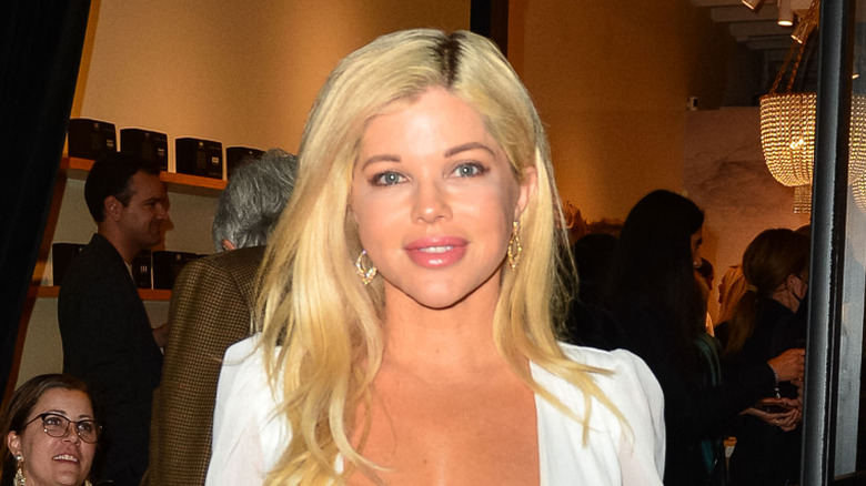 Donna D'Errico smiling in white dress