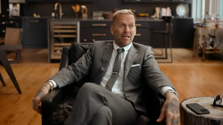 Bob Harper sitting in a chair in a grey suit on the Netflix series