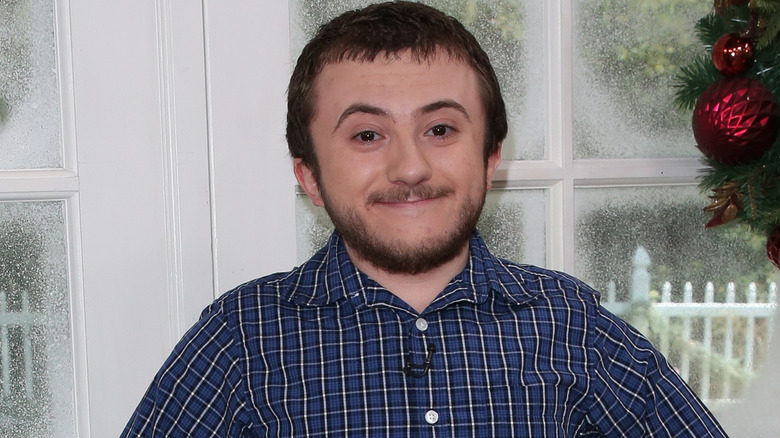 Atticus Shaffer smiling on set for Hallmark's "Home & Family" in 2018.