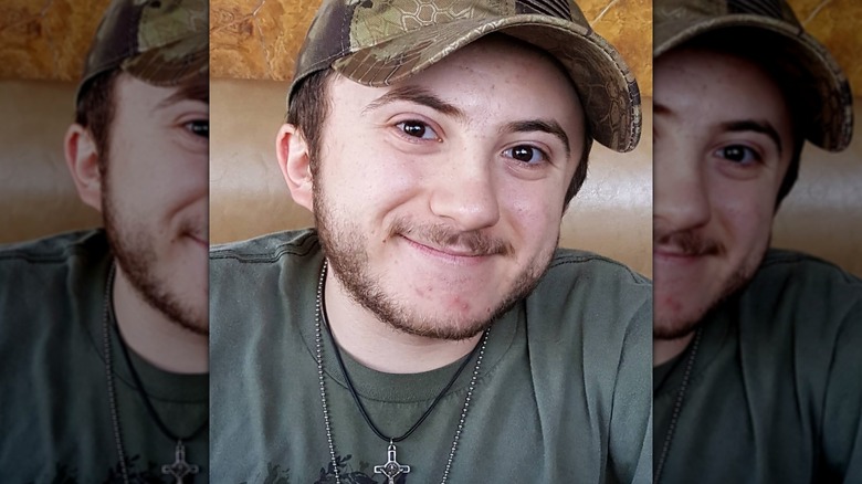 Atticus Shaffer smiling in a booth.