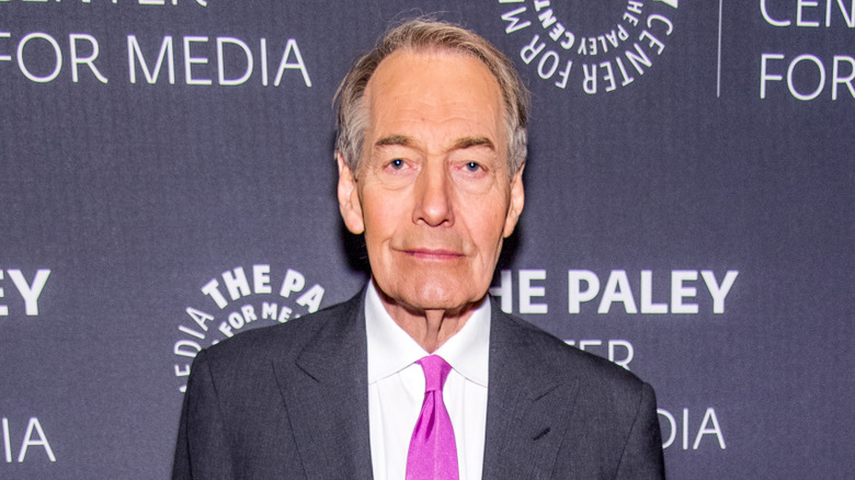 Charlie Rose posing at an event
