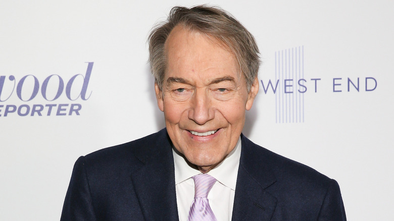 Charlie Rose posing at an event