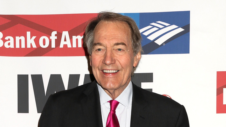 Charlie Rose posing at an event