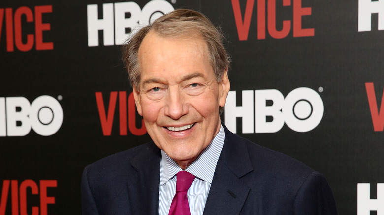 Charlie Rose posing at an event