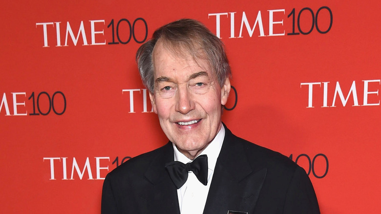 Charlie Rose posing at an event
