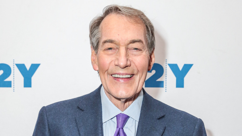 Charlie Rose posing at an event
