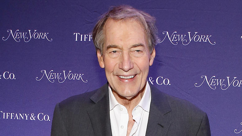 Charlie Rose posing at an event