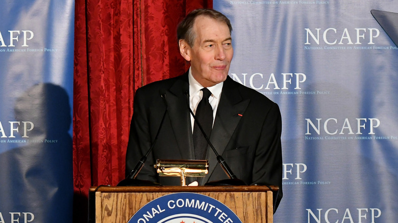 Charlie Rose behind a podium