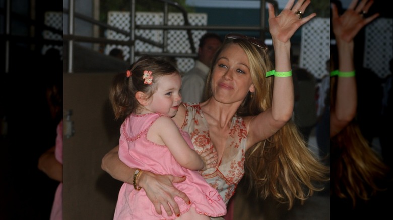 Christine Taylor carries a young Ella in 2004