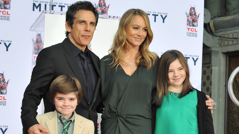 Christine Taylor smiling with Ben and their two kids in 2013