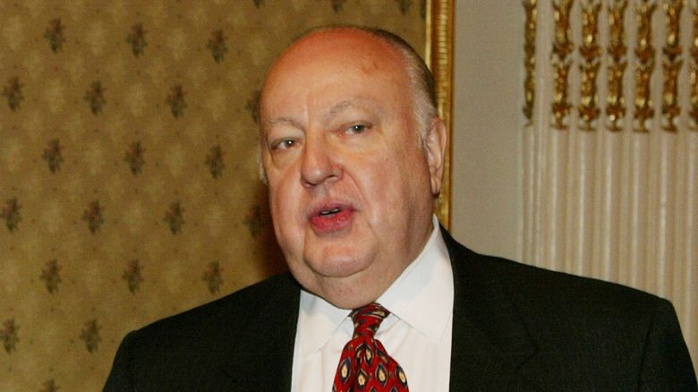 Roger Ailes photographed in front of gold wallpaper