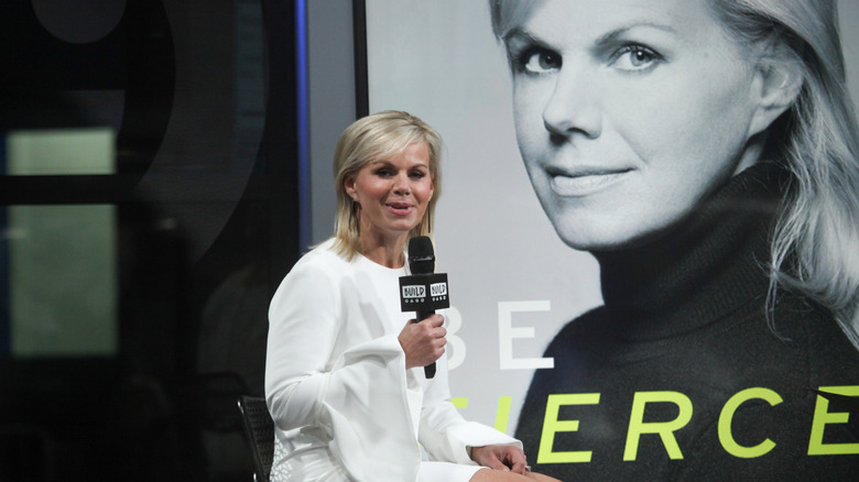 Gretchen Carlson speaking at BUILD Series in front of a poster of her book cover for Be Fierce