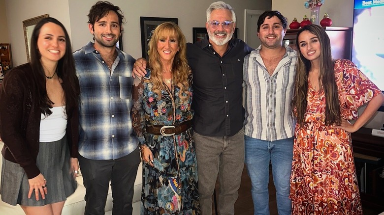 Jazz Jennings stands with her siblings and parents inside smiling.
