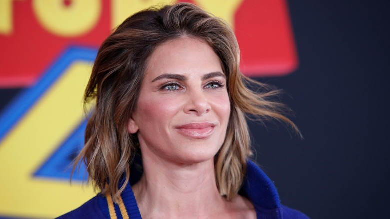Jillian Michaels staring into the middle distance on a blue, red, and yellow background