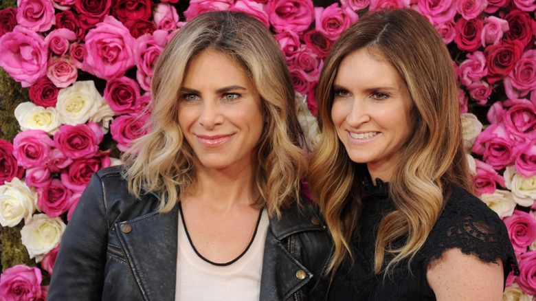 Jillian Michaels and Heidi Rhoades in front of a wall of roses